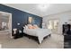 Main bedroom with a blue accent wall and access to backyard at 6701 Choppy Wood Cir, Charlotte, NC 28226