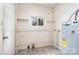 Small laundry room with a water heater and shelves at 823 Frederick St, Shelby, NC 28150