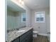 Clean and bright bathroom with granite countertop, modern fixtures, and wood-look flooring at 1014 Kansas St, Kannapolis, NC 28083