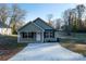Charming green two-story home with a concrete driveway and front yard at 1014 Kansas St, Kannapolis, NC 28083