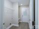 Laundry room with wire shelving, washer/dryer hookups, and exterior door at 1014 Kansas St, Kannapolis, NC 28083