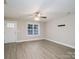 Bright living room with wood-look flooring and ceiling fan at 1014 Kansas St, Kannapolis, NC 28083