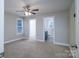 Spacious main bedroom with carpeted floors, ceiling fan, ensuite bathroom, and walk-in closet at 1014 Kansas St, Kannapolis, NC 28083