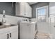 Laundry room with white cabinets and a modern sink at 10121 Enfield Ct, Fort Mill, SC 29707