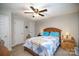 Bedroom featuring carpeted flooring, two closets, a ceiling fan, and ample natural light at 112 Hayworth Ln, Statesville, NC 28625