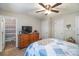 Main bedroom with ceiling fan, wooden dresser, and a bed with blue and white patterned comforter at 112 Hayworth Ln, Statesville, NC 28625