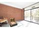 Sunroom with brick wall and sliding glass doors to balcony at 1300 Queens Rd # 405, Charlotte, NC 28207