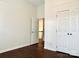 Bedroom with door to loft, double closets and dark brown laminate flooring at 1364 Lloyd Nw Pl, Concord, NC 28027