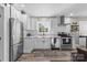 Modern kitchen with white shaker cabinets, stainless steel appliances, and a farmhouse sink at 1522 Princess Pl, Charlotte, NC 28208