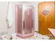 Bathroom features a pink corner shower and wood cabinet at 240 Quail Dr, Salisbury, NC 28147