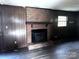 Brick fireplace in living room with wood paneling at 2511 Pickwick Pl, Lincolnton, NC 28092