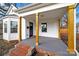 Inviting covered front porch with wooden posts and brick stairs at 306 S Jones Ave, Rock Hill, SC 29730