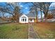 Inviting white cottage with a covered front porch and a fenced yard at 306 S Jones Ave, Rock Hill, SC 29730