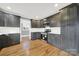 Kitchen with stainless steel appliances, dark cabinets, white backsplash, and an open layout at 306 S Jones Ave, Rock Hill, SC 29730