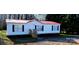 White single-wide mobile home with red roof and small yard at 3431 Polkville Rd, Shelby, NC 28150