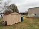 Tan storage shed in backyard of property at 3804 Crossing Creek Dr, Claremont, NC 28610