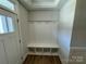 White built-in bench with storage and hooks in the entryway at 4153 Black Ct # 173, Harrisburg, NC 28075