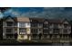 Three-story townhome building with traditional style and landscaping at 5015 Westmead Ln, Charlotte, NC 28262