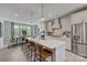 Open kitchen with island, white cabinets, and stainless steel appliances at 5015 Westmead Ln, Charlotte, NC 28262