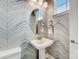 Stylish powder room with unique wallcovering and pedestal sink at 5015 Westmead Ln, Charlotte, NC 28262