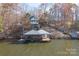 Aerial view of house and boathouse on lakefront property at 638 Deerfield Rd, Mount Gilead, NC 27306