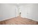 Additional bedroom with wood floors, white walls, and double closet doors at 7673 Katherine Dr, Denver, NC 28037