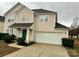 Two-story house with a green door and attached garage at 9011 Korniv Dr, Charlotte, NC 28216