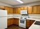 Kitchen with light wood cabinets and white appliances at 9011 Korniv Dr, Charlotte, NC 28216