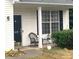 Front porch with rocking chair and small table at 13618 Whitebark Ct, Charlotte, NC 28262