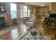 Open living room with kitchen view and hardwood floor at 13618 Whitebark Ct, Charlotte, NC 28262