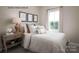 Cozy guest bedroom with a window overlooking the backyard at 2520 Rebecca Ave # 1020E, Charlotte, NC 28208