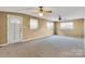 Bright living room with neutral carpeting and ceiling fans at 300 Duke St, Great Falls, SC 29055