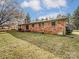 Brick house back view with deck, storage tank, and large yard at 313 Lake Montonia Rd, Kings Mountain, NC 28086