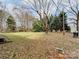Large backyard with trees, shed, and grassy area at 313 Lake Montonia Rd, Kings Mountain, NC 28086