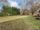 Large backyard with trees, shed, and grassy area at 313 Lake Montonia Rd, Kings Mountain, NC 28086