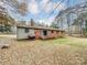Brick house back view with deck, storage tank, and large yard at 313 Lake Montonia Rd, Kings Mountain, NC 28086