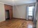 Bright bedroom with hardwood floors and built-in wooden closet at 325 Hunter St, Salisbury, NC 28144