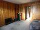 Cozy living room with wood paneling, a TV, and small refrigerator at 325 Hunter St, Salisbury, NC 28144