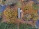 Aerial view showing a mobile home with surrounding trees at 44267 Yadkin Brick Rd, New London, NC 28127