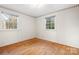 Bedroom with hardwood floors and two windows at 5006 Hoyt Ct, Charlotte, NC 28210