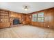 Gathering room with wood paneling and brick fireplace at 5006 Hoyt Ct, Charlotte, NC 28210