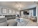 Spacious living room with gray sectional sofa, white coffee table, and built-in shelving at 604 Oldham Ln, Rock Hill, SC 29732