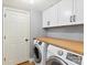 Convenient laundry room with washer, dryer, and ample counter space at 8700 Tamarron Dr, Charlotte, NC 28277