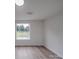 Bright bedroom with large window, wood-look flooring, and ample natural light at 1190 Holshouser Rd, Rockwell, NC 28138