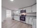 Modern kitchen featuring white cabinets, granite countertops, and stainless steel appliances at 1190 Holshouser Rd, Rockwell, NC 28138