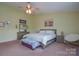 King bedroom with decorative bedding and ceiling fan at 2004 Oakbriar Cir, Indian Trail, NC 28079