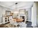 Elegant dining room with wood table and white chairs, fireplace at 2315 Smith Harbour Dr, Denver, NC 28037