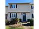 Tan two-story townhouse with black shutters and a paved walkway at 3274 Heathstead Pl, Charlotte, NC 28210