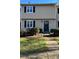 Tan two-story townhouse with black shutters and a paved walkway at 3274 Heathstead Pl, Charlotte, NC 28210