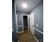 Hallway with gray walls, light wood flooring, and coat closet at 3274 Heathstead Pl, Charlotte, NC 28210